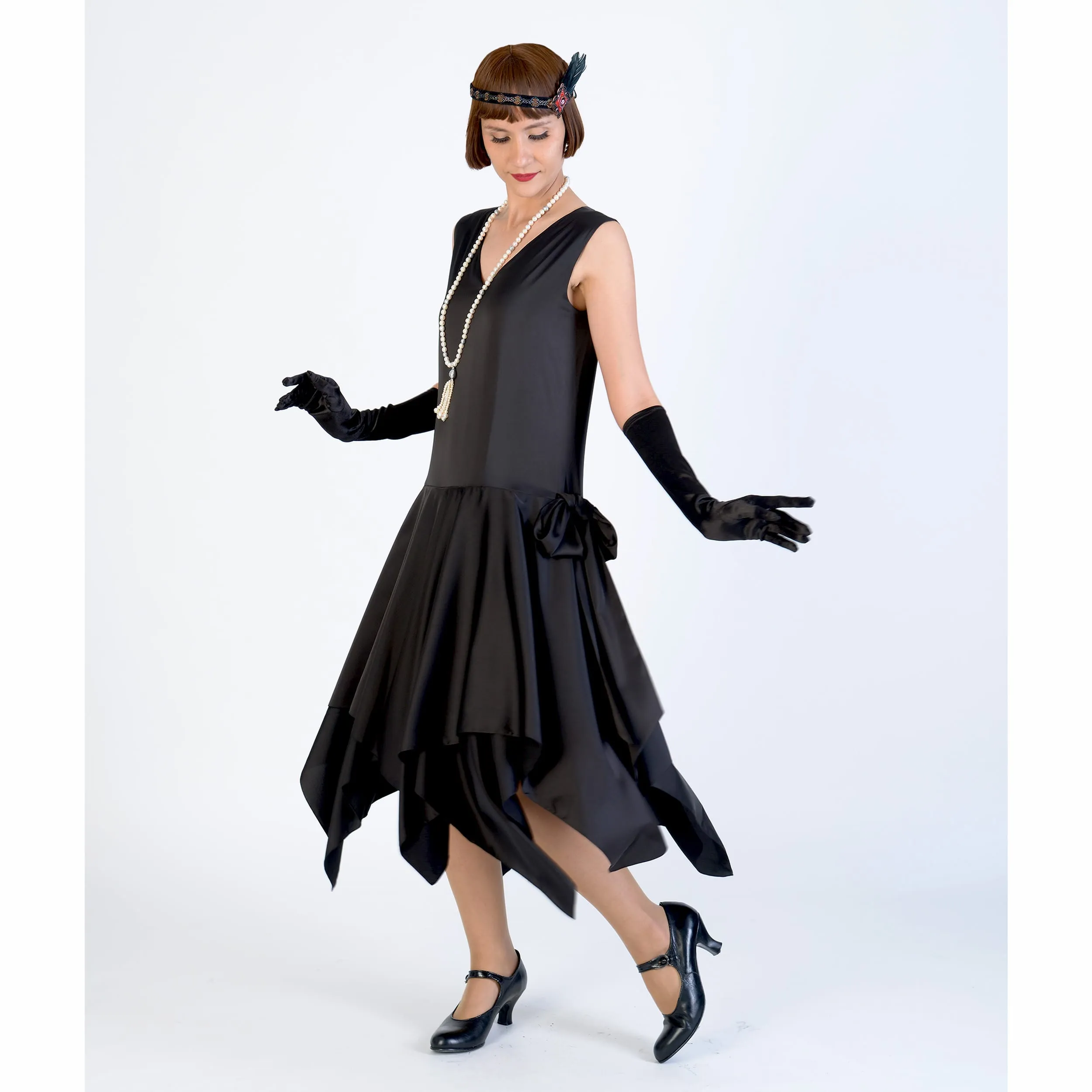 Black 1920s evening dress of satin with handkerchief skirt