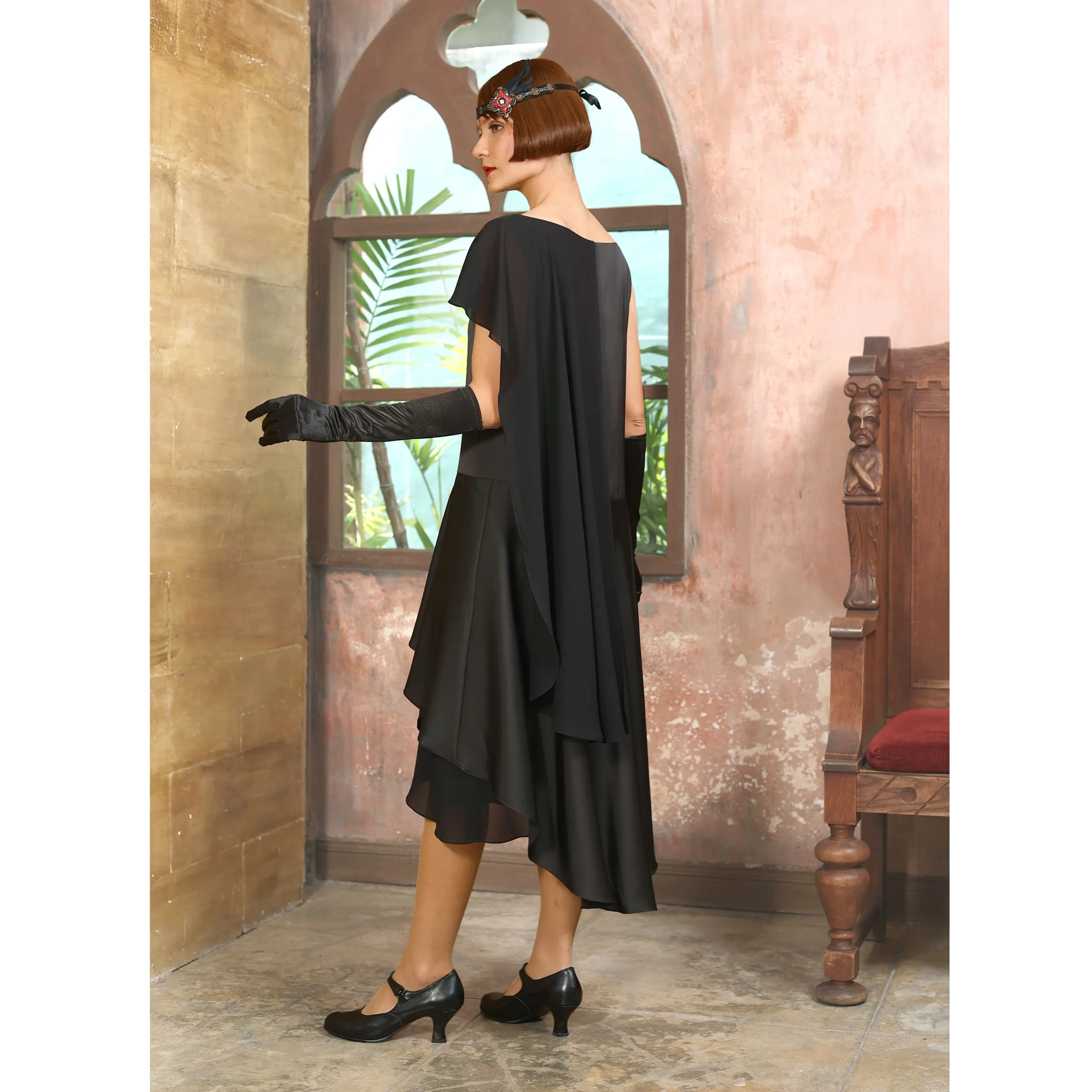 Black 1920s formal evening satin dress with a shoulder train